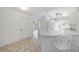 Open-concept kitchen features a breakfast bar, leading into other living spaces with neutral decor at 611 Mobile Rd, Venice, FL 34293