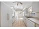 Well-lit white kitchen with modern appliances and plenty of counter space, opening to dining area at 611 Mobile Rd, Venice, FL 34293