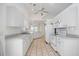 Clean, white kitchen with ample cabinet space, modern appliances, and seamless flow to adjacent areas at 611 Mobile Rd, Venice, FL 34293