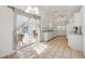 Bright kitchen with white cabinets, tile flooring, and sliding door with pool view at 611 Mobile Rd, Venice, FL 34293