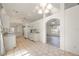 Bright kitchen featuring white cabinetry, tile flooring, and modern appliances open to the living area at 611 Mobile Rd, Venice, FL 34293