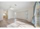 Bright living room featuring wood floors, ceiling fan, natural light, and sliding glass doors at 611 Mobile Rd, Venice, FL 34293