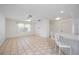 Bright living space with tile floors, a ceiling fan, and breakfast bar creating an open floor plan at 611 Mobile Rd, Venice, FL 34293