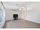 Spacious living room featuring vaulted ceilings, light wood flooring, and large window at 611 Mobile Rd, Venice, FL 34293