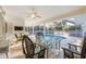 Enclosed patio featuring covered seating area overlooking swimming pool at 611 Mobile Rd, Venice, FL 34293