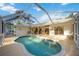 A gorgeous in-ground screened pool is surrounded by a deck with direct access to the home's interior at 611 Mobile Rd, Venice, FL 34293