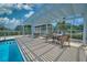 Community pool and patio area with tables, chairs, and pergola at 6311 Grand Oak Cir # 202, Bradenton, FL 34203