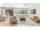 Spacious living room featuring a comfortable sectional sofa and large TV at 655 Resolute St, Nokomis, FL 34275