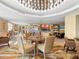 Well-lit breakfast room with tables, chairs, and a food bar at 915 Seaside Dr # 407, Sarasota, FL 34242