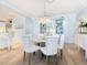 Bright dining room featuring a round table and built-in shelving at 915 Seaside Dr # 407, Sarasota, FL 34242
