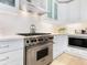 Sleek kitchen with stainless steel range and white cabinets at 915 Seaside Dr # 407, Sarasota, FL 34242