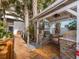 Outdoor kitchen with grill, stone counters, and a covered patio area at 915 Seaside Dr # 407, Sarasota, FL 34242