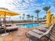 Relaxing pool area with lounge chairs and umbrellas at 915 Seaside Dr # 407, Sarasota, FL 34242