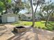 Landscaped backyard with a fire pit and detached garage at 1127 41St St, Sarasota, FL 34234