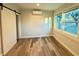 Bright bedroom with wood-look floors and sliding barn door at 1127 41St St, Sarasota, FL 34234