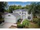 Charming two-story home with a well-manicured lawn, lush landscaping, and solar panels at 228 36Th Ne St, Bradenton, FL 34208