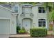 Welcoming front entrance features elegant double doors, arched windows, and charming landscaping at 228 36Th Ne St, Bradenton, FL 34208