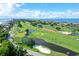 Aerial view of lush golf course community near the ocean at 535 Sanctuary Dr # A202, Longboat Key, FL 34228