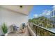 Small balcony with seating for two and tropical landscaping at 535 Sanctuary Dr # A202, Longboat Key, FL 34228