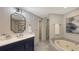 Spa-like bathroom with soaking tub and double vanity at 535 Sanctuary Dr # A202, Longboat Key, FL 34228