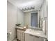 Modern bathroom with marble vanity and large mirror at 535 Sanctuary Dr # A202, Longboat Key, FL 34228