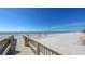 Beach access with boardwalk stairs leading to sandy beach at 535 Sanctuary Dr # A202, Longboat Key, FL 34228