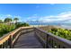 Wooden boardwalk leads to pristine sandy beach at 535 Sanctuary Dr # A202, Longboat Key, FL 34228