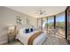 Bright bedroom with a king-size bed and access to a balcony at 535 Sanctuary Dr # A202, Longboat Key, FL 34228