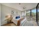 Spacious bedroom with large windows and balcony access at 535 Sanctuary Dr # A202, Longboat Key, FL 34228