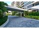 Modern building entrance with covered walkway and landscaped grounds at 535 Sanctuary Dr # A202, Longboat Key, FL 34228