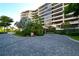 Elegant condo building entrance with landscaped grounds at 535 Sanctuary Dr # A202, Longboat Key, FL 34228