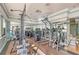 Fitness center with strength training equipment and mirrors at 535 Sanctuary Dr # A202, Longboat Key, FL 34228