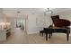 Hallway with grand piano and access to balcony at 535 Sanctuary Dr # A202, Longboat Key, FL 34228