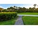 Brick pathway meanders through lush landscaping toward beach at 535 Sanctuary Dr # A202, Longboat Key, FL 34228