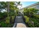 Landscaped walkway with stairs leading to building entrance at 535 Sanctuary Dr # A202, Longboat Key, FL 34228