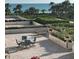 Oceanfront patio with seating, providing a tranquil outdoor space at 535 Sanctuary Dr # A202, Longboat Key, FL 34228