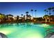 Night view of resort-style pool with palm trees at 535 Sanctuary Dr # A202, Longboat Key, FL 34228