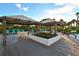 Relaxing pool deck with covered seating at 535 Sanctuary Dr # A202, Longboat Key, FL 34228