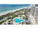 Aerial view of resort-style pool and beach access at 535 Sanctuary Dr # A202, Longboat Key, FL 34228