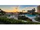 Evening view of resort-style pool and deck area at 535 Sanctuary Dr # A202, Longboat Key, FL 34228