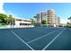 Well-maintained tennis courts with building view at 535 Sanctuary Dr # A202, Longboat Key, FL 34228