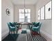 Elegant dining room featuring a stylish table, chairs, and patterned rug at 8332 Sea Glass Ct, Sarasota, FL 34240