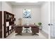 Well-lit home office with built-in shelves and a large desk at 8332 Sea Glass Ct, Sarasota, FL 34240