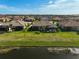 Aerial view of community with houses and pond at 4734 Tortona Ct, Bradenton, FL 34211