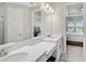 Double vanity bathroom with bedroom view at 4734 Tortona Ct, Bradenton, FL 34211