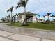 Community clubhouse with palm trees and flag at 4734 Tortona Ct, Bradenton, FL 34211