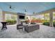Comfortable community lounge area with sofas, fireplace, and a large TV at 4734 Tortona Ct, Bradenton, FL 34211