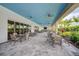 Relaxing community patio with multiple seating areas, ceiling fans, and a TV at 4734 Tortona Ct, Bradenton, FL 34211