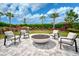 Round fire pit with seating area in landscaped area at 4734 Tortona Ct, Bradenton, FL 34211