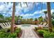 Relaxing hot tub surrounded by lounge chairs and lush landscaping at 4734 Tortona Ct, Bradenton, FL 34211